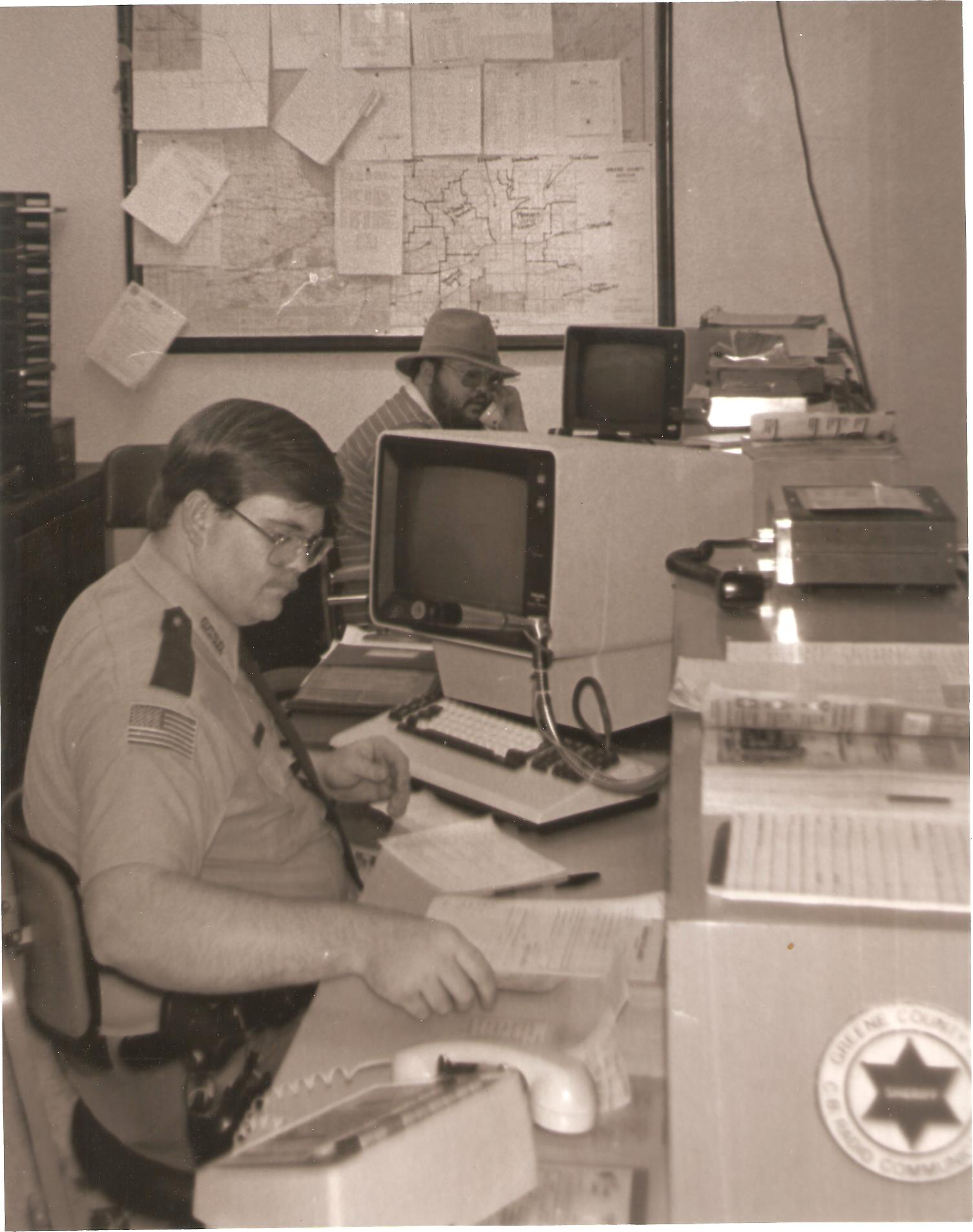 Working behind the radio console at the Greene County Sheriff's Department alongside fellow Deputy Sheriff Morris D. "Sonny" Jarvis. circa 1987